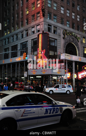 Nachtaufnahme NYPD Polizei Auto geparkt am Straßenrand, in Richtung Neon Gitarre Hard Rock Cafe, West 43rd Street Ecke 7th Avenue, New York Stockfoto