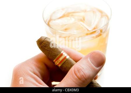 Eine Zigarre mit einem Whiskeyglass unscharf halten im Hintergrund Stockfoto