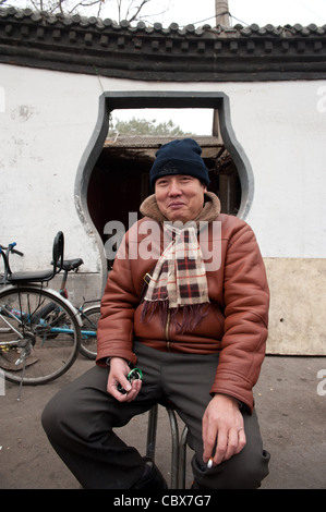 Xiadian, Beijing. Ein Arbeiter eines Bezirks Heizwerk, sitzt vor seinem Haus. Stockfoto