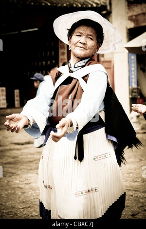 Eine traditionelle Naxi-Frau tanzen in Sifang Jie Square in Dayan, alte Stadt Lijiang, Yunnan, Südwestchina. Stockfoto