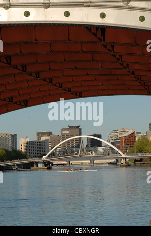 Blick von St. Kilda Road Bridge auf dem Yarra River Southbank (li.) und CBD (r) durch eine Fußgängerbrücke in Melbourne, Victoria verbunden Stockfoto