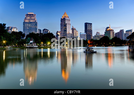 Blick Richtung Silom & Rama IV Road vom Lumpini Park in der Abenddämmerung, Bangkok. Stockfoto