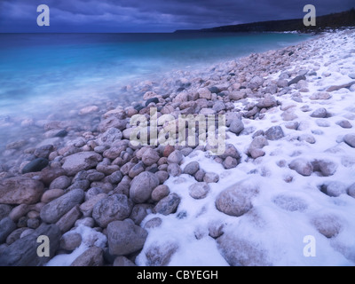 Kiesel auf einem Ufer der georgischen Bucht bedeckt mit leichten Schnee. Malerische Landschaft Winter. Bruce Peninsula National Park, Ontario Stockfoto