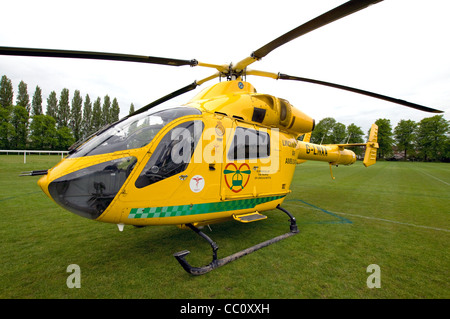 Nottinghamshire Luft Rettungshubschrauber landete auf dem Fußballplatz, Bäume im Hintergrund Stockfoto