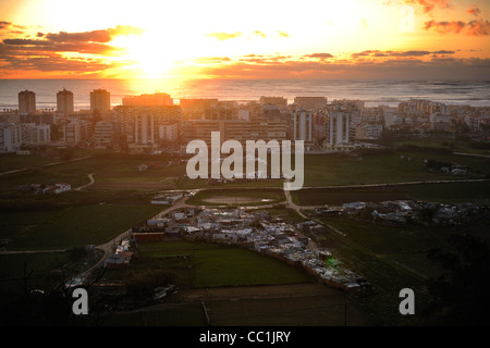 Sonnenuntergang über der Skyline von Costa da Caparica mit dem Atlantischen Ozean im Hintergrund, Almada, Setúbal, Portugal Stockfoto