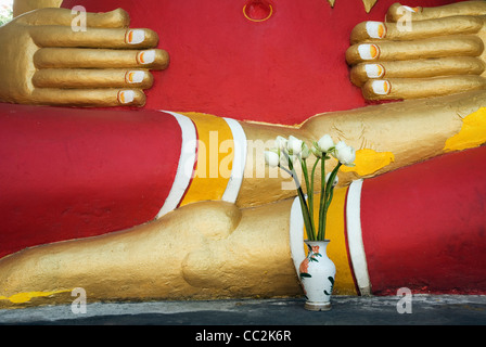 Ein Angebot von Lotusblüten sitzt vor einem chinesischen Buddha-Statue im Wat Chedi Luang - Chiang Mai, THAILAND Stockfoto