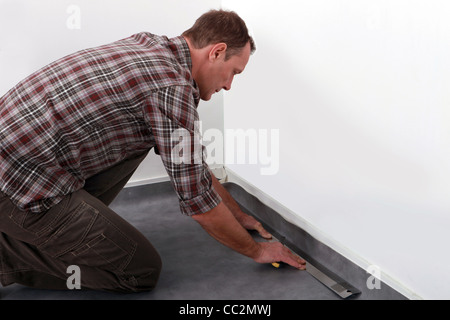 Handwerker, die Festlegung von Linoleumboden Stockfoto