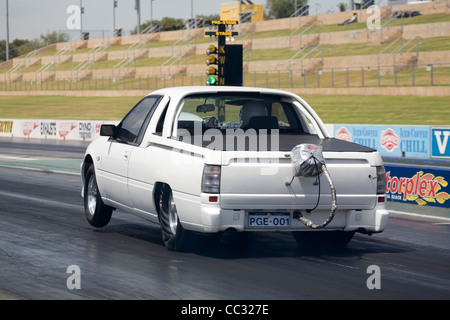 Australischen Drag-Racing, die Holden Commodore Ute LKW abholen startet hart auf das grüne Licht und hebt die Vorderräder an. Stockfoto