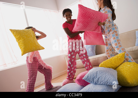 USA, California, Los Angeles, drei Mädchen (10-11), die Kissen zu kämpfen, im Pyjama-party Stockfoto