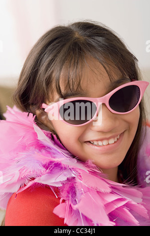Porträt von lächelndes Mädchen (10-11) tragen Federboa und eine Sonnenbrille, Los Angeles, California, USA Stockfoto