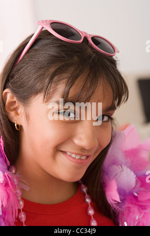 Porträt von lächelndes Mädchen (10-11) tragen Federboa und eine Sonnenbrille, Los Angeles, California, USA Stockfoto
