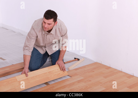 Mann, die Verlegung von Laminat in Wohnung Stockfoto