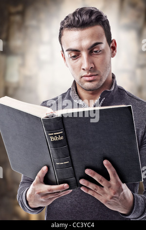 Porträt eines jungen Mannes, der die Heilige Bibel lesen Stockfoto