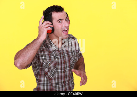 Mann trägt Gehörschutz Stockfoto