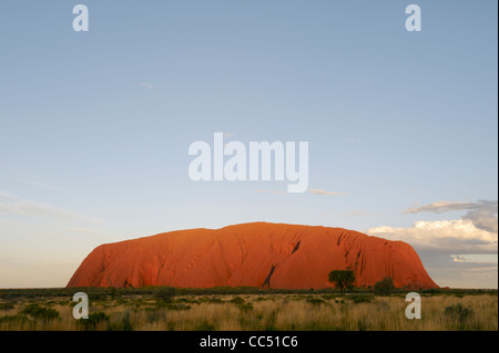 Sonnenuntergang am Uluru; Ayers Rock leuchtet Orange unter der Einstellung Sonne, Uluru-Kata Tjuta National Park, Northern Territory, Australien Stockfoto