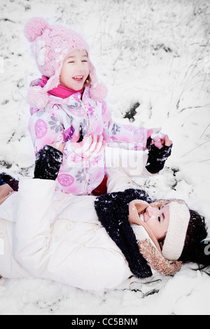 Mama und Tochter haben Spaß im Schnee Stockfoto