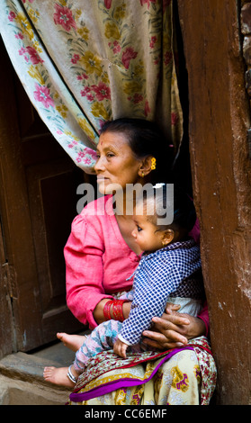 Mutter und Kind von ihrem Haus in Patan sitzt. Stockfoto