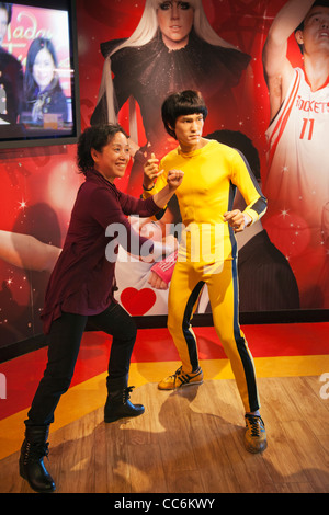 China, Hong Kong, der Peak Tower, Madame Tussauds, touristische posiert mit Statue von Bruce Lee Stockfoto