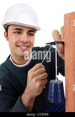 Baumeister kontrollierenden Wand Stockfoto