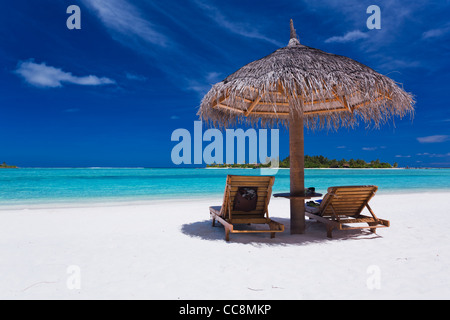 Zwei Stühle und Sonnenschirm am atemberaubenden tropischen Strand Stockfoto