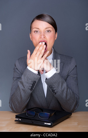 Portrait von junge hübsche Frau mit Brille und Touch-Pad-Computer in ihrem Büro sitzen Stockfoto