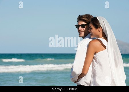 Braut und Bräutigam umarmt am Strand Stockfoto