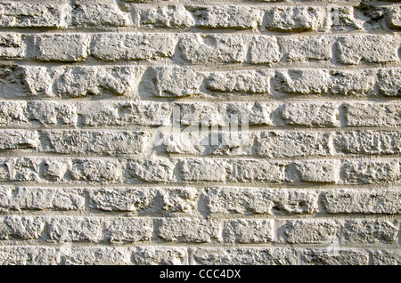 Hintergrund alten, gemauerten Wand Sonnenlicht Sonne. Architektonische Closeup Kulisse. Stockfoto