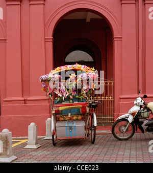 Touristische Velo-rikscha außerhalb Christus Kirche in Dutch Square in Malacca Melaka in Malaysia in Fernost Südostasien. Tourismus Beruf Reisen Stockfoto