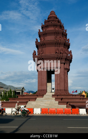 Eine Fahrrad-Rikscha / Cyclo, eine Form der erneuerbaren Energie, Peddles um einen Verkehrskreis am Independence Monument, Phnom Penh, Kambodscha. © Kraig Lieb Stockfoto