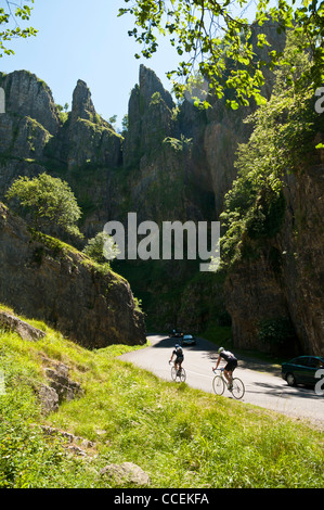 Zwei Radfahrer erklimmen den Hügel durch Cheddar Gorge an einem sehr sonnigen Tag im Frühsommer. Stockfoto