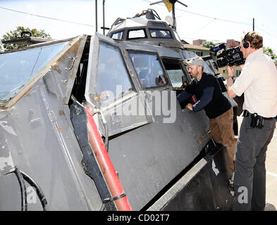 IMAX filmmaker Sean Casey, center, talks with his assistant Byron Turk,  right, about modifications he wants to make to the TIV or Tornado Intercept  Vehicle, an armored 1997 Ford F-450 diesel pickup