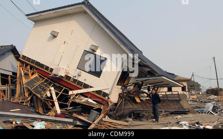 2. April 2011 - Narahara, Japan - sieht ein Mann in seinem Haus von dem Erdbeben und dem Tsunami in Iwaki, Fukushimapräfektur, Japan ist reduziert. 3 Tage vom 1. April, Japan und US-Streitkräfte gemeinsam Suche nach verschwundenen durch Tsunami und Erdbeben sowohl von Himmel und Meer. Noch 16000 Menschen ar Stockfoto