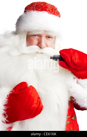 Traditionellen Weihnachtsmann hält 3g USB-Modem im Arm im Vordergrund. Isoliert auf weiss. Stockfoto