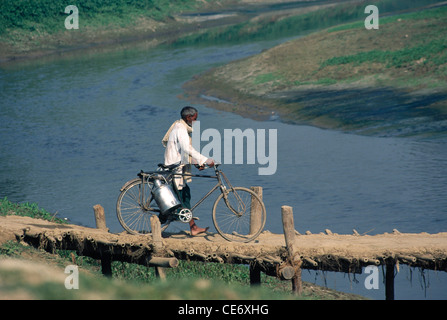 RSC 85435: indische Milchmann Milch kann mit dem Fahrrad überqueren Holzbrücke am Fluss Indien Stockfoto