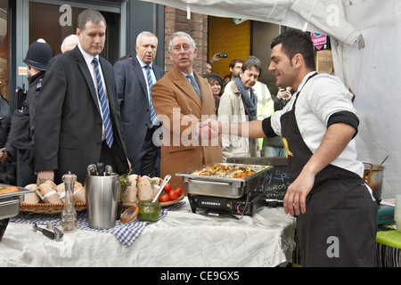 Prinz Charles versucht italienisches Essen, zubereitet von Alessio Garau (rechts) bei einem Besuch in unteren Marsh Markt, Waterloo, London. Stockfoto