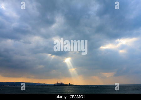 Sonnenstrahlen, Sonnenlicht strömt durch kleine Löcher in die Wolken, Danshui Fluss, Taipei, Taiwan Stockfoto