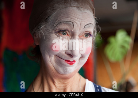 Seniorin im Whiteface Clown Make-up zieht eine Reihe von lustigen Gesichtern. Bild 5 von 8 Stockfoto