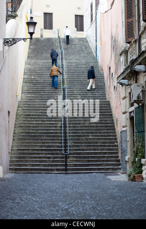 Vier Männer Klettern eine sehr steile Stein Treppe in Roma Italien Stockfoto