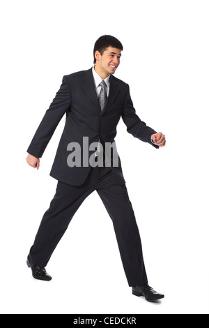 junge asiatische Geschäftsmann Ganzkörper Spaziergänge lächelnd Stockfoto