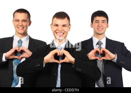 Drei junge lächelnde Geschäftsleute zeigen Liebe Zeichen von Händen Stockfoto