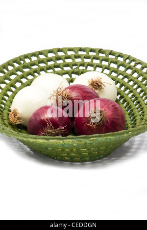 Weiße und rote Zwiebeln in einem Korb auf weißem Hintergrund Stockfoto