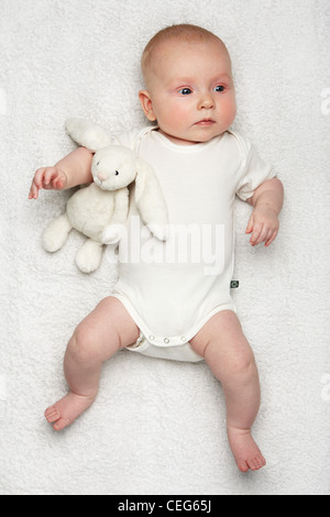 Baby mit weißer Weste mit Hase Stofftier (mit Model-Release) Stockfoto