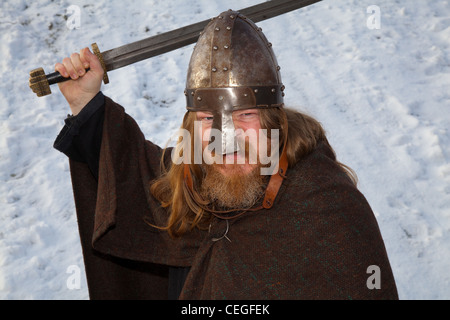 Ingolfui (MR) Isländer Wikinger Mittelalter-Reenaktor, mit Bart tragen Metallhelm & tragen ein erhöhtes Schwert; 27th Annual JORVIK Festival in York, UK Stockfoto