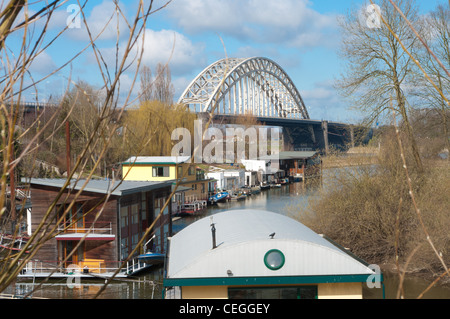 Hausboote, neben der Brücke über den Fluss Waal bei Nijmegen Stockfoto