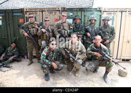 Indonesische Soldaten posieren für ein Gruppenfoto mit US-Marineinfanteristen der 31. Marine Expeditionary Unit während der simulierten nicht-kämpferischen Evakuierungsoperationen Rayong, Königreich Thailand, 12. Februar 2012. Das Royal Thai Marine Corps, die US-Marine, die Japan Self Defense Forces, die malaysischen und singapurischen Streitkräfte nahmen alle an der NEO-Ausbildung während der Übung Cobra Gold 2012 Teil. Die Übung verbessert die Fähigkeit, gemeinsame Operationen zu planen und durchzuführen, Beziehungen zwischen den Partnerländern aufzubauen und die Interoperabilität in der Region Asien-Pazifik zu verbessern Stockfoto