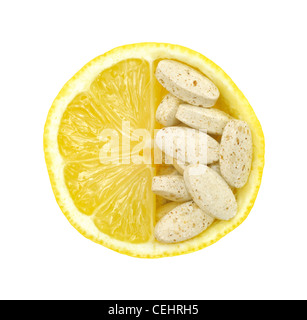 Close up of fresh lemon and pills isolated – vitamin concept - white background Stockfoto