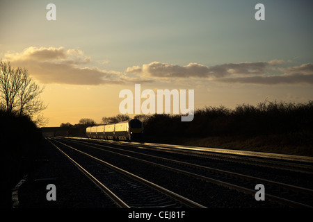East Midlands Züge Klasse 222 Meridian fängt am frühen Morgen Glint Sonnenlicht bei Cossington Fuß überqueren. Stockfoto