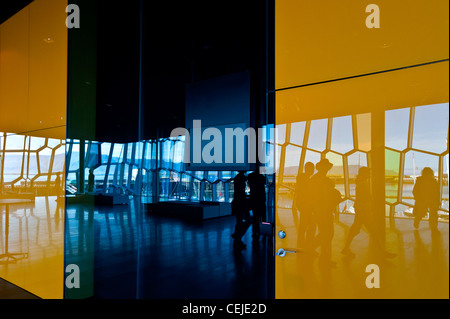 Reflexion der Gruppe von Menschen in bunten Wand bereisen Harpa Konzertsaal "Harfe" in Reykjavik, Island. Stockfoto