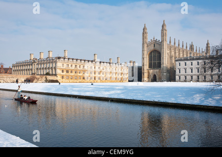 Stochern am Ufer des Flusses Cam im Winter Schnee mit Kings College Chapel nach hinten. Cambridge, England.