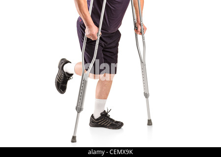 Ein verletzter Mann auf Krücken auf weißen Hintergrund isoliert Stockfoto